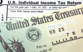 An image of income tax documents and a refund check.