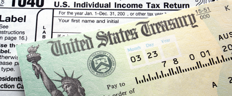 An image of income tax documents and a refund check.