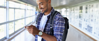 An image of a young man looking at his cellphone.